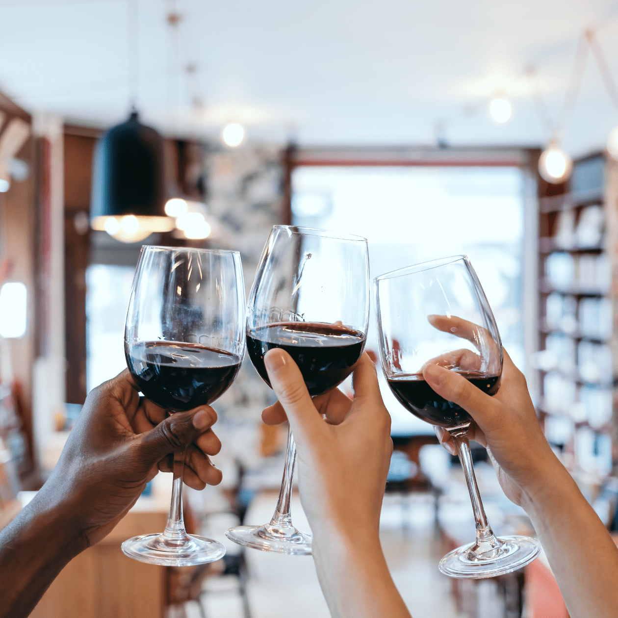 Cheersing glasses of red wine | DRINKS
