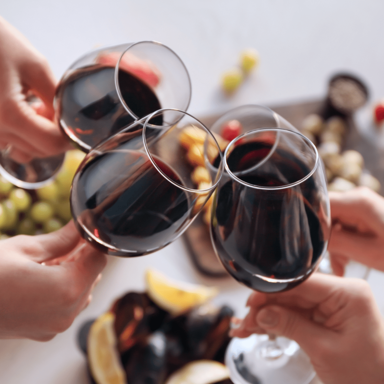 Cheersing glasses of red wine | DRINKS